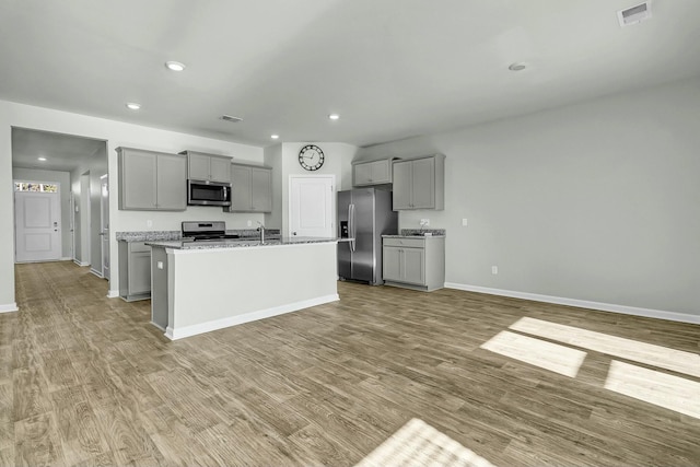 kitchen with visible vents, appliances with stainless steel finishes, gray cabinetry, and wood finished floors