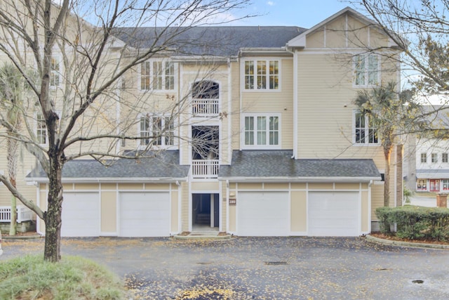 view of front facade featuring a balcony and a garage