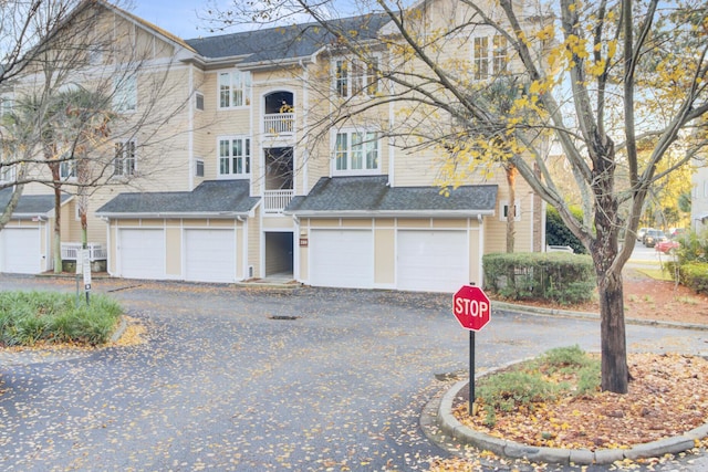 view of front of home with a garage and a balcony