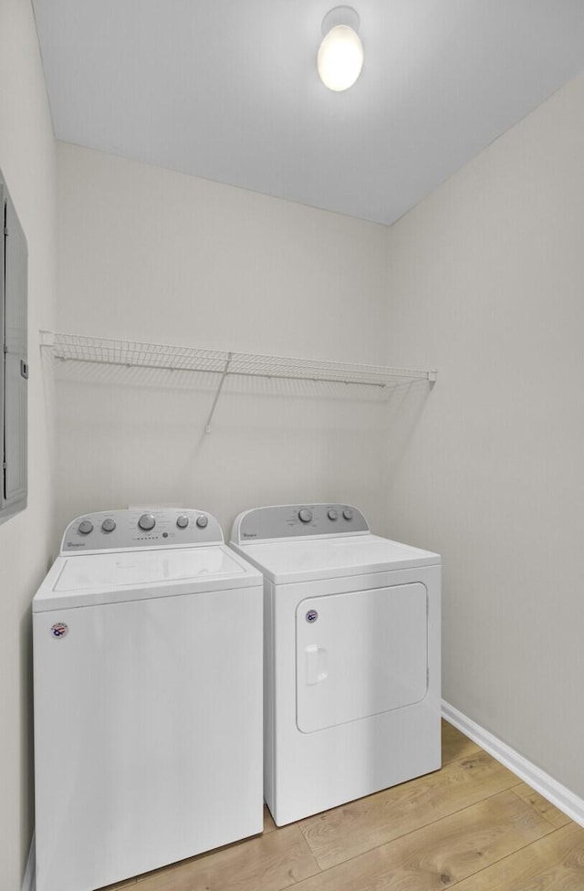 laundry room featuring separate washer and dryer and hardwood / wood-style floors