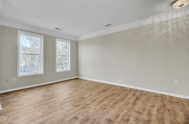 unfurnished room with ornamental molding and light hardwood / wood-style flooring