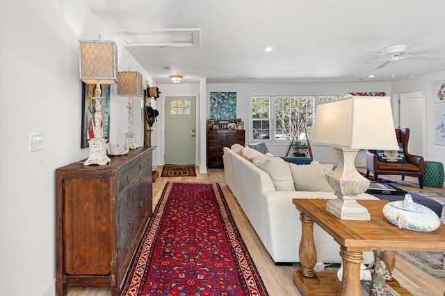 living room featuring ceiling fan and light hardwood / wood-style flooring