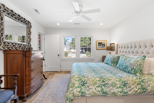 bedroom with light hardwood / wood-style flooring and ceiling fan