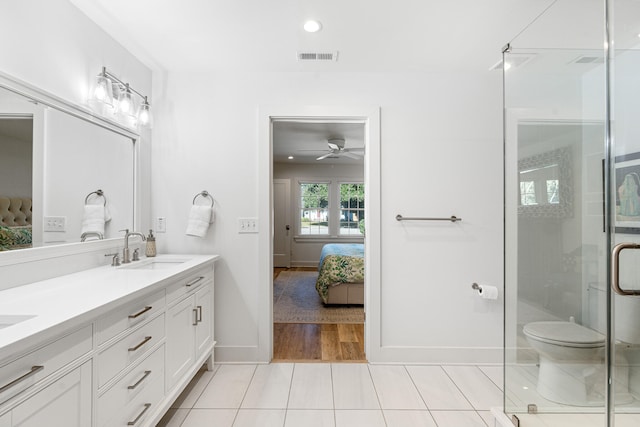 bathroom with walk in shower, vanity, ceiling fan, wood-type flooring, and toilet