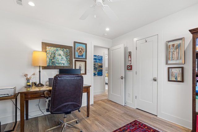 office space with ceiling fan and light hardwood / wood-style flooring