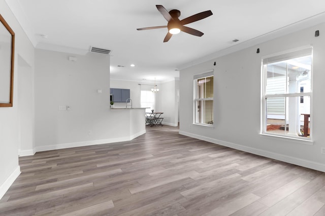 5242 E Dolphin St, North Charleston, SC 29405 - unfurnished living room with a ceiling fan, wood finished floors, ornamental molding, a chandelier, and recessed lighting