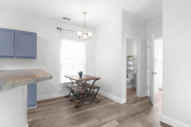 5242 E Dolphin St, North Charleston, SC 29405 - dining space with a chandelier and light wood-style floors