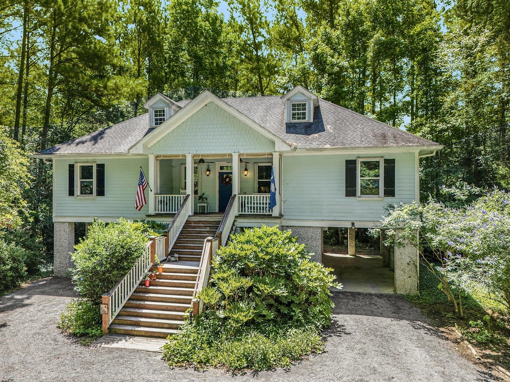 view of front of property featuring a carport and covered porch