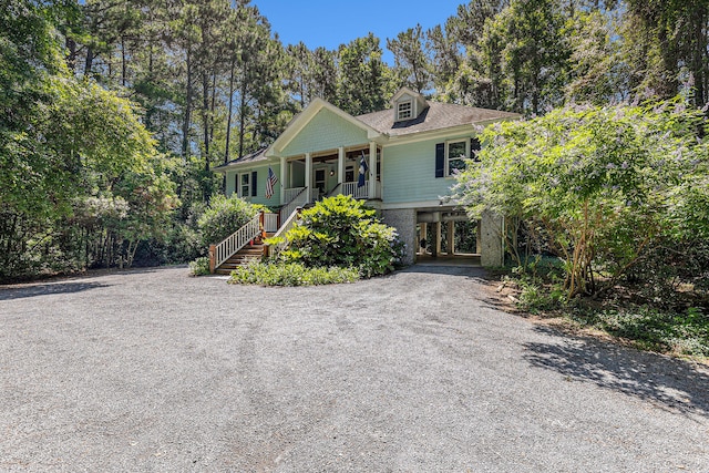 view of front of home with a carport and a porch