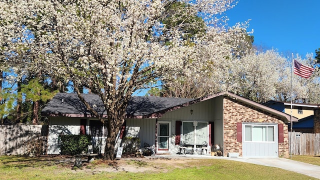 back of house with fence, a lawn, and brick siding