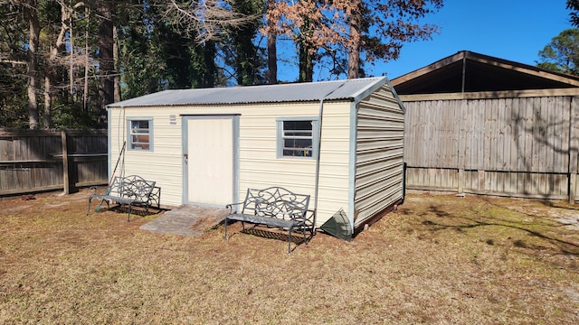 view of shed with a fenced backyard