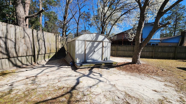 exterior space featuring a storage unit, an outdoor structure, and a fenced backyard