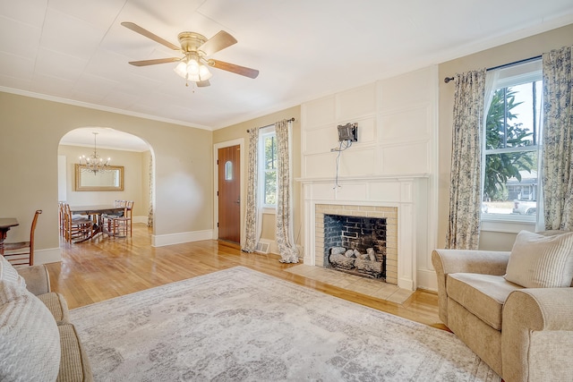 living room with ceiling fan, hardwood / wood-style flooring, and ornamental molding