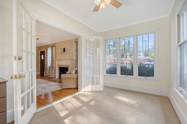 unfurnished sunroom with ceiling fan and french doors