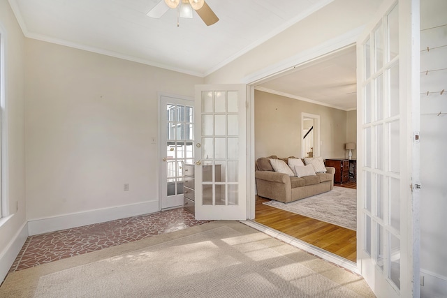 interior space with ornamental molding, french doors, wood-type flooring, and ceiling fan