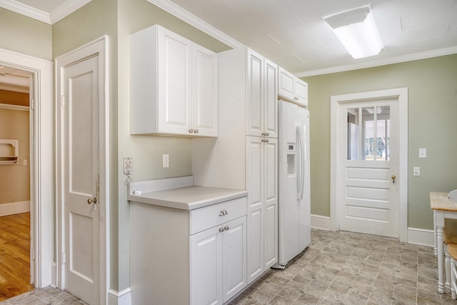 kitchen with white cabinets, light hardwood / wood-style flooring, crown molding, and white refrigerator with ice dispenser