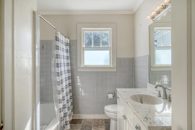 full bathroom with tile walls, vanity, shower / bath combo with shower curtain, and crown molding