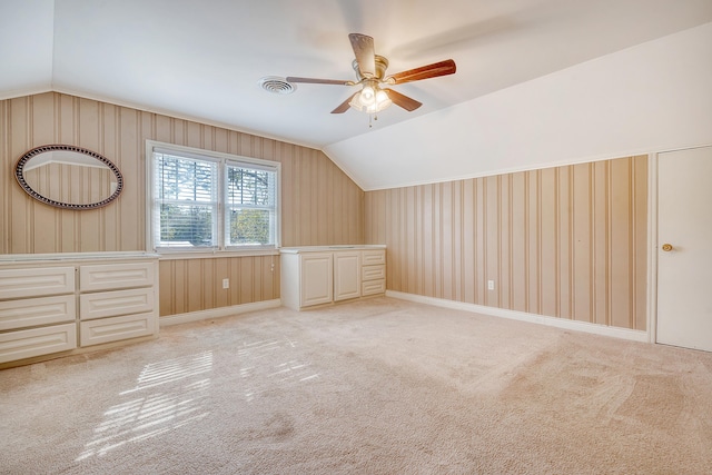 bonus room with vaulted ceiling, light carpet, and ceiling fan