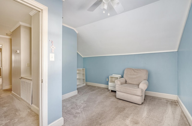 living area featuring light colored carpet, ceiling fan, crown molding, and vaulted ceiling