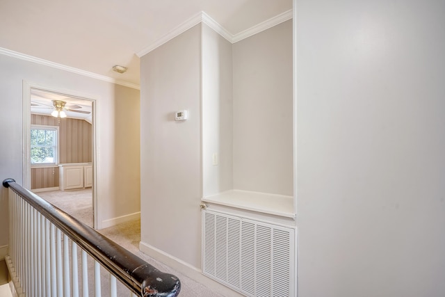 corridor featuring light colored carpet and crown molding