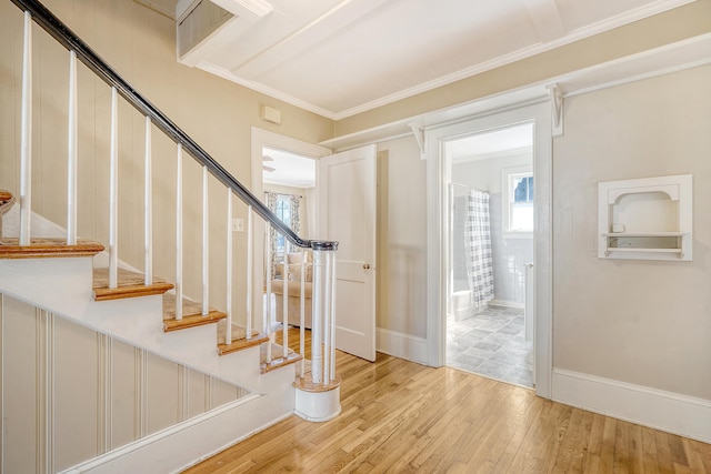 entrance foyer with crown molding and light hardwood / wood-style flooring