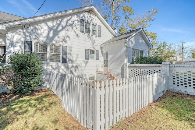 rear view of house featuring a yard