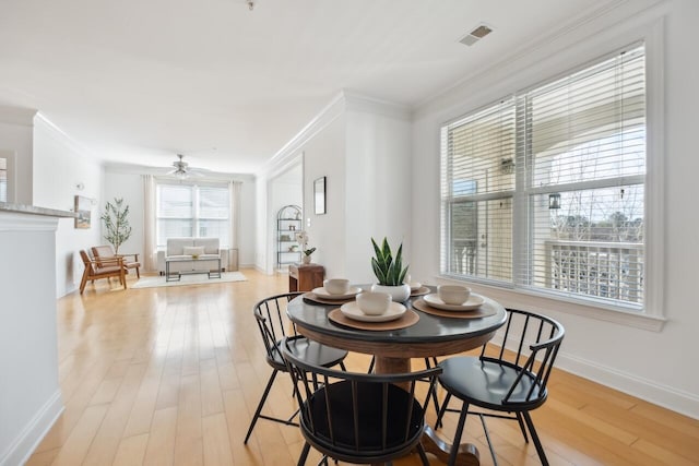 dining room featuring ceiling fan, light hardwood / wood-style flooring, and crown molding