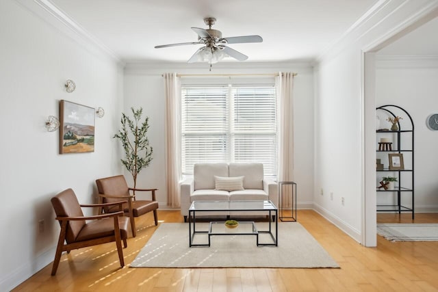 living area featuring ceiling fan, ornamental molding, and light hardwood / wood-style floors