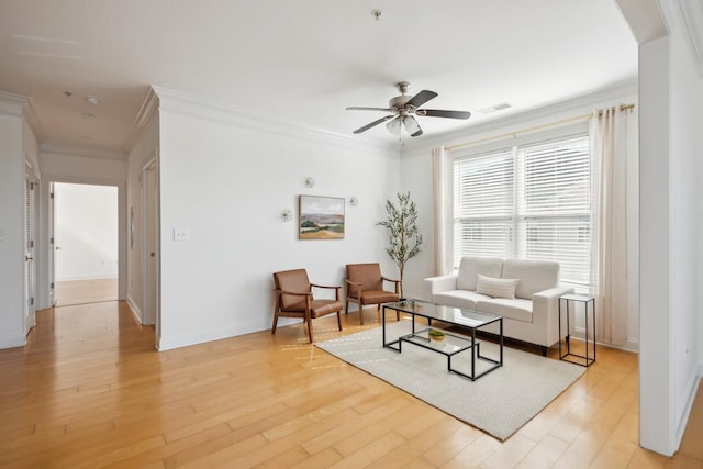 living room featuring ornamental molding, ceiling fan, and light hardwood / wood-style flooring