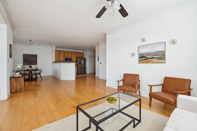 living room featuring light hardwood / wood-style flooring, ceiling fan, and ornamental molding