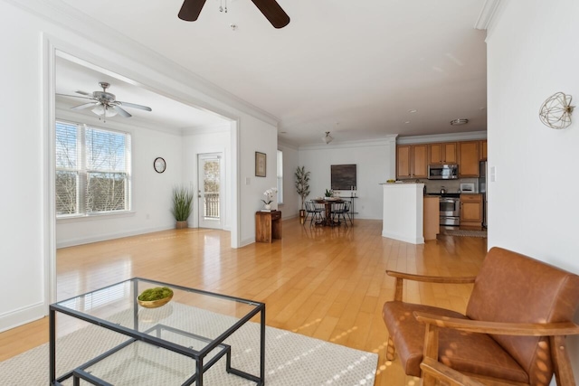 living room with ornamental molding and light wood-type flooring