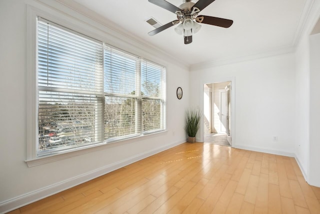 unfurnished room featuring ornamental molding, ceiling fan, and light hardwood / wood-style flooring