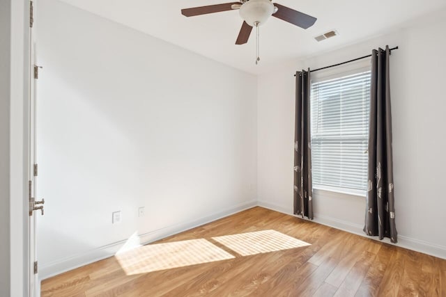 empty room featuring ceiling fan and light hardwood / wood-style flooring