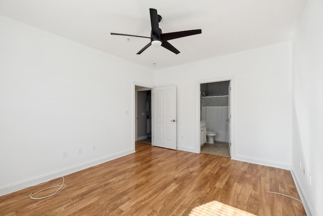 unfurnished bedroom with light wood-type flooring, connected bathroom, and ceiling fan