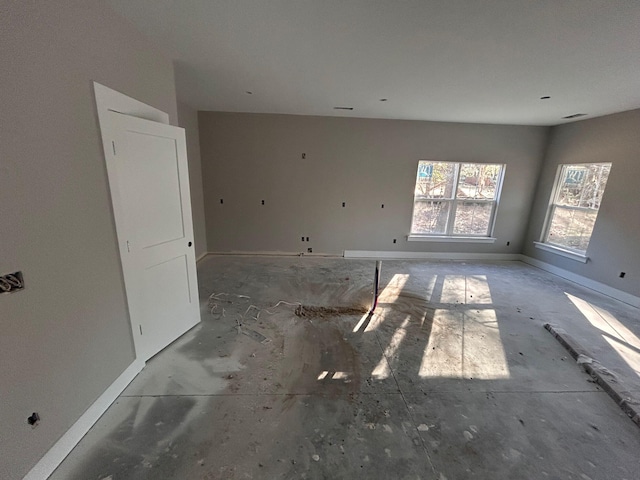 unfurnished room featuring visible vents and baseboards