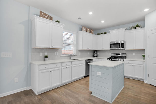 204 Honey Horn Dr, Summerville, SC 29486 - kitchen with light wood-style flooring, light countertops, white cabinets, appliances with stainless steel finishes, and a sink