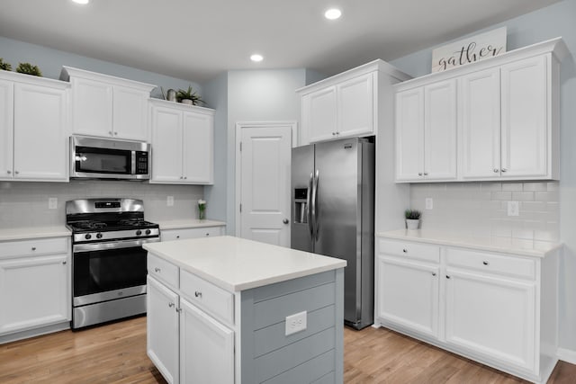 204 Honey Horn Dr, Summerville, SC 29486 - kitchen featuring light wood-style flooring, appliances with stainless steel finishes, light countertops, and white cabinetry
