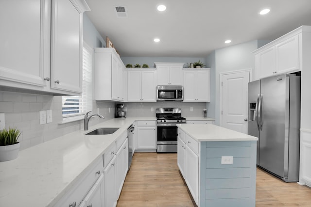 204 Honey Horn Dr, Summerville, SC 29486 - kitchen with visible vents, a sink, light wood-style floors, white cabinetry, and stainless steel appliances