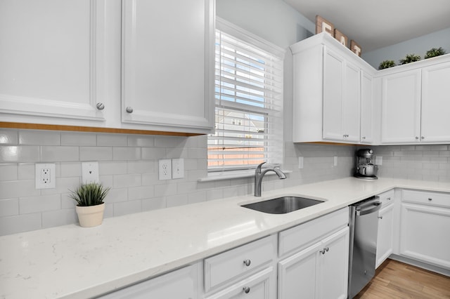 204 Honey Horn Dr, Summerville, SC 29486 - kitchen with white cabinets, dishwasher, a sink, light wood-type flooring, and decorative backsplash