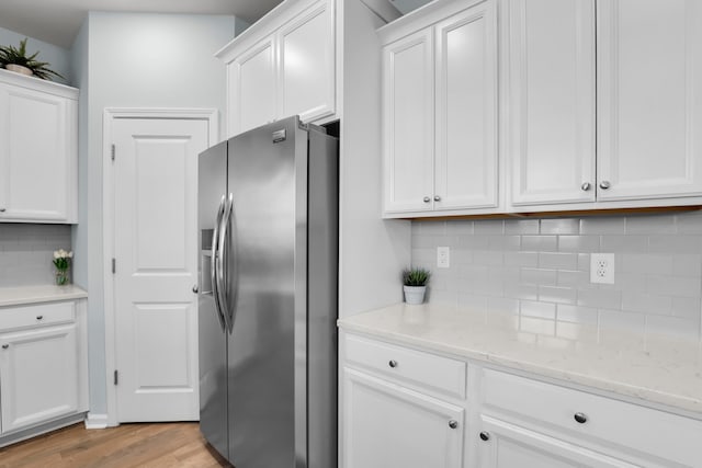 204 Honey Horn Dr, Summerville, SC 29486 - kitchen featuring stainless steel fridge, light wood-style floors, white cabinetry, light stone countertops, and backsplash
