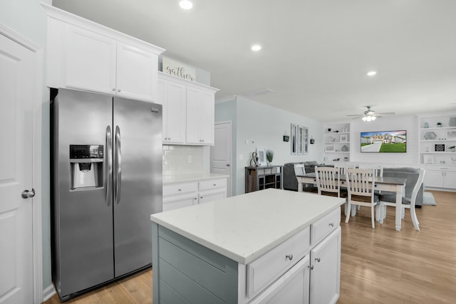 204 Honey Horn Dr, Summerville, SC 29486 - kitchen featuring light wood-type flooring, a center island, white cabinetry, a ceiling fan, and stainless steel refrigerator with ice dispenser