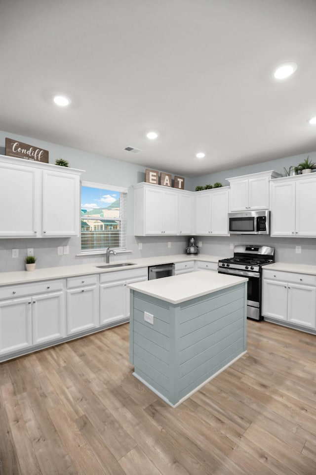 204 Honey Horn Dr, Summerville, SC 29486 - kitchen featuring a center island, light countertops, white cabinetry, light wood-style floors, and stainless steel appliances