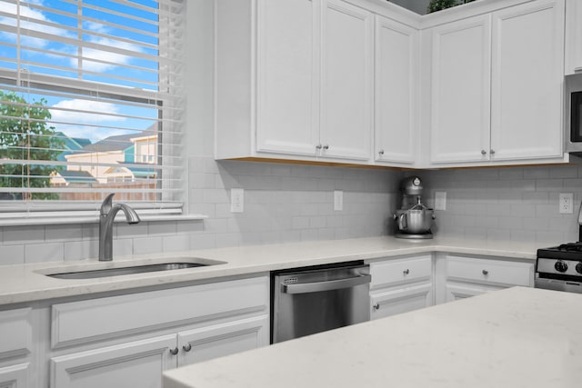 204 Honey Horn Dr, Summerville, SC 29486 - kitchen featuring white cabinetry, light stone counters, a sink, stainless steel appliances, and decorative backsplash