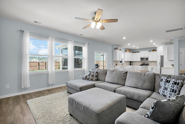 204 Honey Horn Dr, Summerville, SC 29486 - living room featuring light wood-style flooring, visible vents, ceiling fan, and baseboards