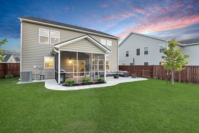 204 Honey Horn Dr, Summerville, SC 29486 - back of house at dusk with central AC, outdoor lounge area, a sunroom, a fenced backyard, and a lawn