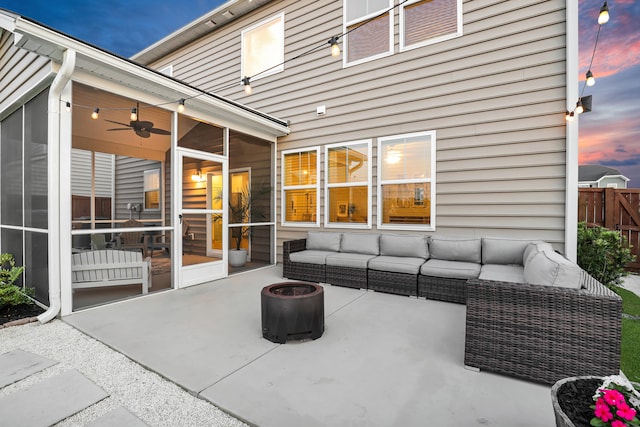 204 Honey Horn Dr, Summerville, SC 29486 - patio terrace at dusk with a sunroom, an outdoor living space with a fire pit, and fence