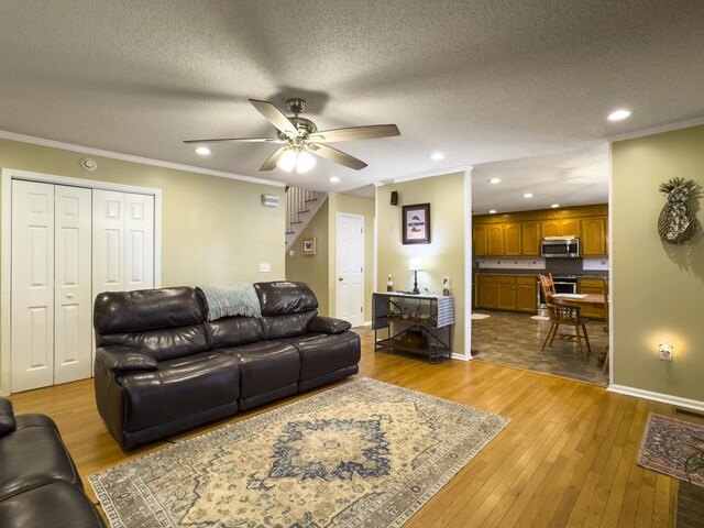 5505 Indigo Makers Trce, Charleston, SC 29418 - living room with a ceiling fan, a textured ceiling, wood-type flooring, ornamental molding, and recessed lighting