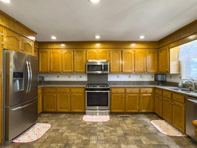 5505 Indigo Makers Trce, Charleston, SC 29418 - kitchen with a sink, appliances with stainless steel finishes, brown cabinets, and a textured ceiling
