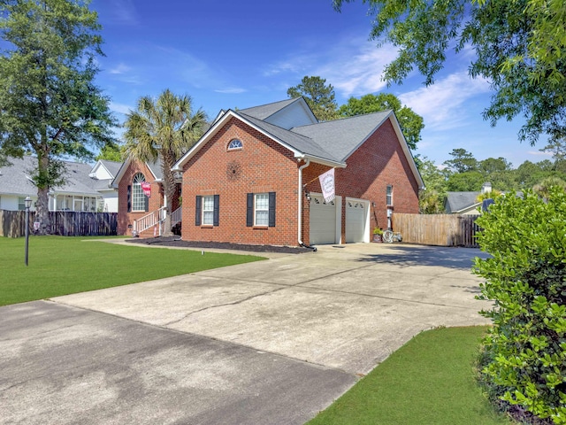 5505 Indigo Makers Trce, Charleston, SC 29418 - view of front facade with a front yard, brick siding, fence, concrete driveway, and an attached garage