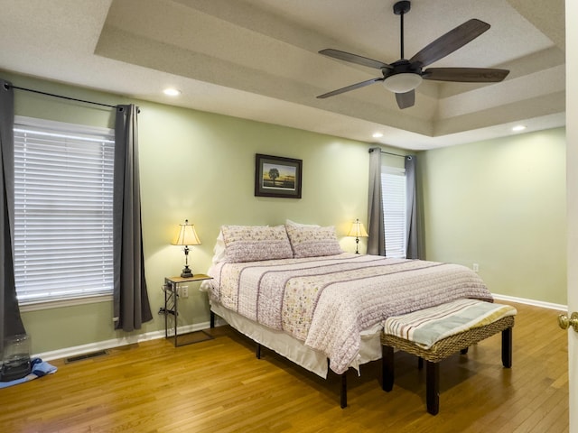 5505 Indigo Makers Trce, Charleston, SC 29418 - bedroom featuring a raised ceiling, baseboards, light wood-type flooring, and visible vents